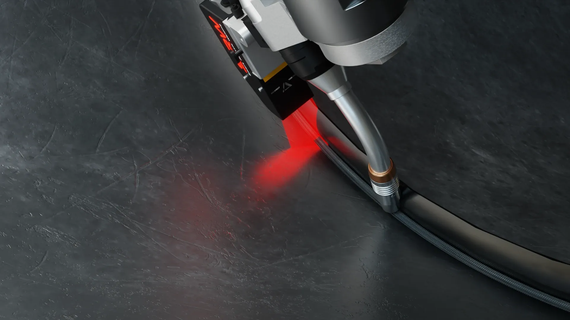 Robotic welding torch with a red laser sensor following a curved joint